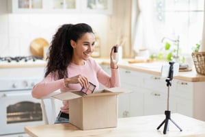 Woman filming unboxing video