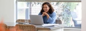 Smiling woman sitting at her laptop