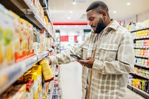 Man selecting product from grocery shelf